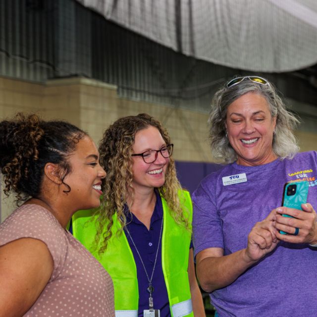 Staff members viewing cell phone content 